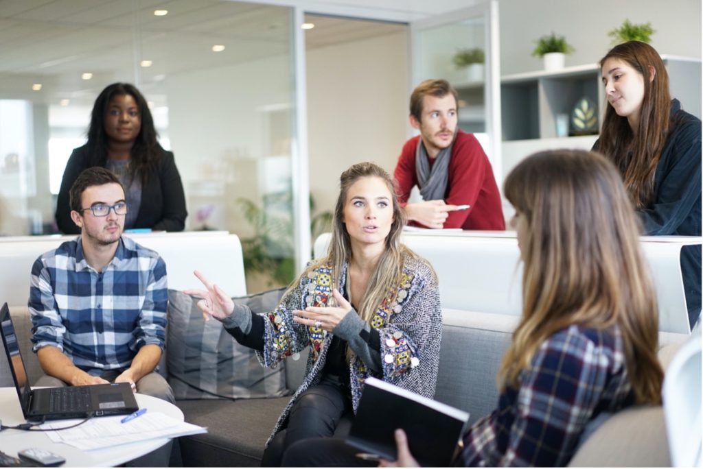 This image shows a work meeting with a woman speaking