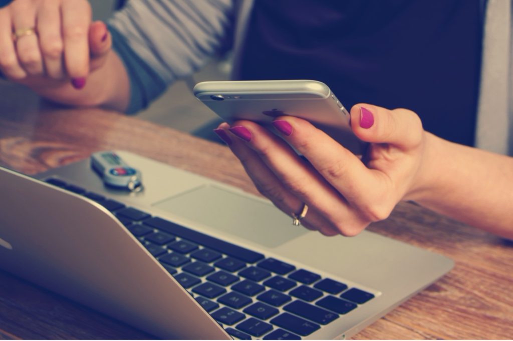 This image shows a woman holding a cellphone.